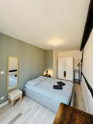 Un ou plusieurs lits dans un hébergement de l'établissement Charmant appartement centre Dijon