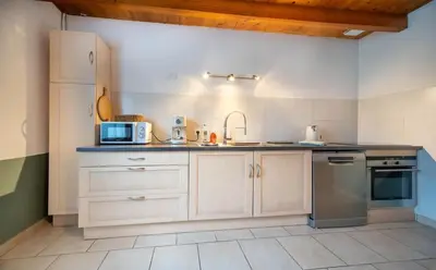 Cuisine ou kitchenette dans l'établissement L'Orée du Bois