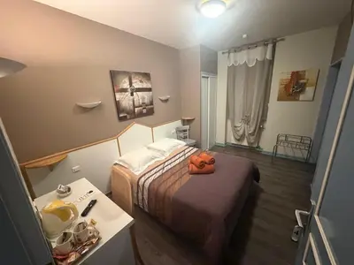Un ou plusieurs lits dans un hébergement de l'établissement Hôtel du Centre
