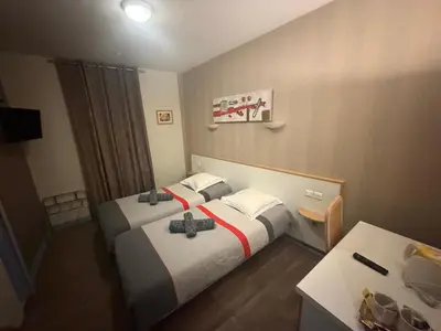Un ou plusieurs lits dans un hébergement de l'établissement Hôtel du Centre