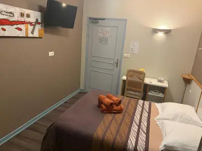 Un ou plusieurs lits dans un hébergement de l'établissement Hôtel du Centre