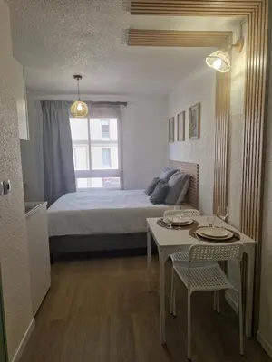 Un ou plusieurs lits dans un hébergement de l'établissement Le Cosy 213 des Logis de Paray Studio Downtown