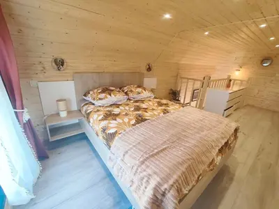 Un ou plusieurs lits dans un hébergement de l'établissement chalet bohème au calme
