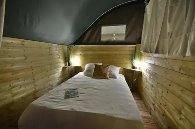 Un ou plusieurs lits dans un hébergement de l'établissement Camping Du Paquier Fané