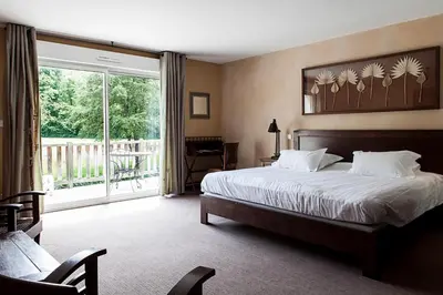 Un ou plusieurs lits dans un hébergement de l'établissement Hôtel La Gentilhommière