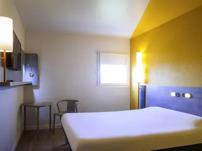 Un ou plusieurs lits dans un hébergement de l'établissement ibis budget Nuits Saint Georges