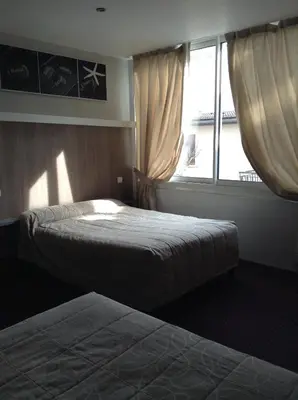 Un ou plusieurs lits dans un hébergement de l'établissement Hôtel Du Stade