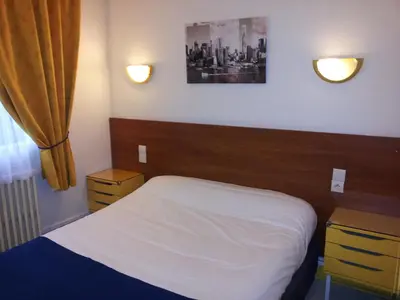 Un ou plusieurs lits dans un hébergement de l'établissement Hôtel Du Stade