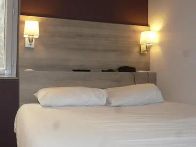 Un ou plusieurs lits dans un hébergement de l'établissement Hôtel Montchapet Dijon Centre