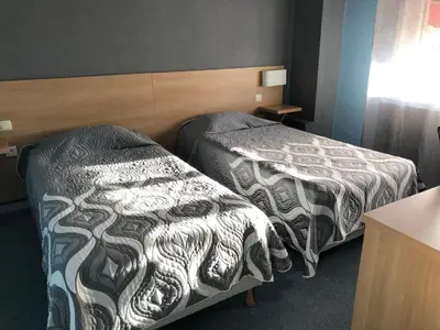 Un ou plusieurs lits dans un hébergement de l'établissement Hotel Restaurant Saint-Benoit