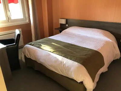 Un ou plusieurs lits dans un hébergement de l'établissement Hotel Restaurant Saint-Benoit