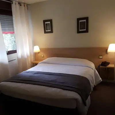 Un ou plusieurs lits dans un hébergement de l'établissement Hotel Restaurant Saint-Benoit