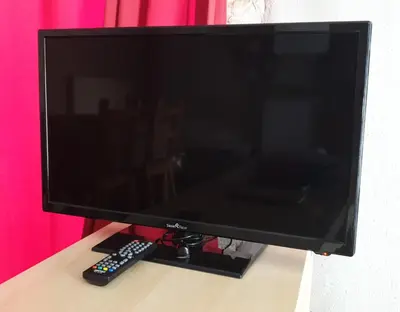 Télévision ou salle de divertissement dans l'établissement Appartement La Poulotte
