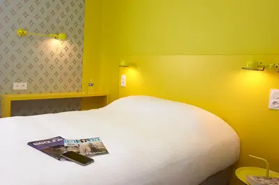 Un ou plusieurs lits dans un hébergement de l'établissement Coto Hotel
