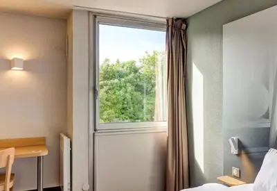 Un ou plusieurs lits dans un hébergement de l'établissement B&B HOTEL Beaune Sud 1 Palais des Congrès