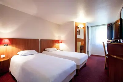 Un ou plusieurs lits dans un hébergement de l'établissement Hôtel Inn Design Mâcon Nord - Sancé
