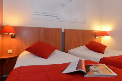 Un ou plusieurs lits dans un hébergement de l'établissement Hôtel Inn Design Dijon Est - Quetigny