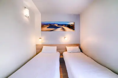 Un ou plusieurs lits dans un hébergement de l'établissement Brit Hotel Macon Nord Autoroute du Soleil
