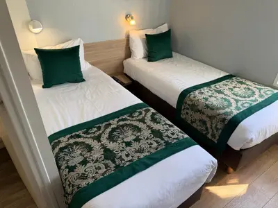 Un ou plusieurs lits dans un hébergement de l'établissement Brit Hotel Macon Nord Autoroute du Soleil