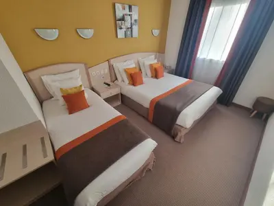 Un ou plusieurs lits dans un hébergement de l'établissement Hôtel Le Kolibri