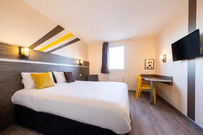 Un ou plusieurs lits dans un hébergement de l'établissement Kyriad Dijon Sud - Longvic