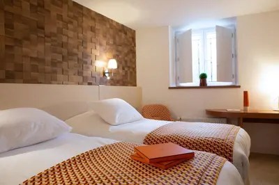 Un ou plusieurs lits dans un hébergement de l'établissement Hotel Le Clos De La Vouge