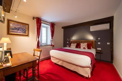 Un ou plusieurs lits dans un hébergement de l'établissement Teritoria Hôtel Wilson