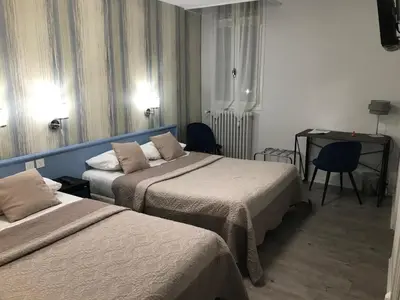 Un ou plusieurs lits dans un hébergement de l'établissement Hôtel Saint Philibert