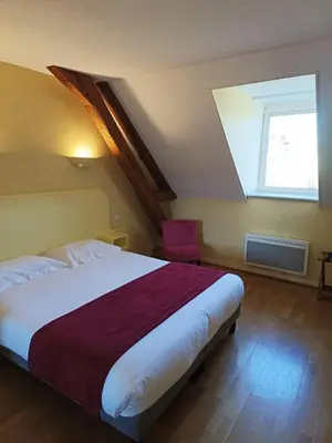 Un ou plusieurs lits dans un hébergement de l'établissement Hôtel La Reconce