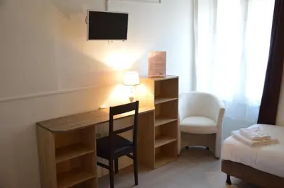 Un ou plusieurs lits dans un hébergement de l'établissement Hôtel de la Colombière