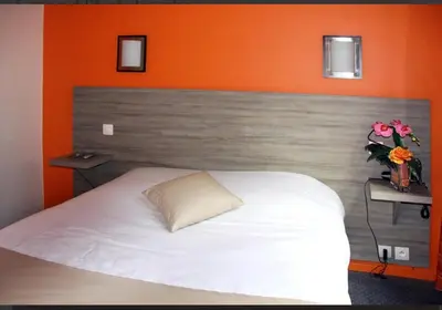 Un ou plusieurs lits dans un hébergement de l'établissement Hôtel de la Colombière