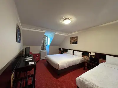 Un ou plusieurs lits dans un hébergement de l'établissement Hostellerie St Vincent
