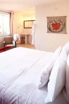 Un ou plusieurs lits dans un hébergement de l'établissement Auberge Du Paradis