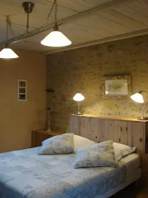 Un ou plusieurs lits dans un hébergement de l'établissement La Pierre Folle Chambres d'Hôtes