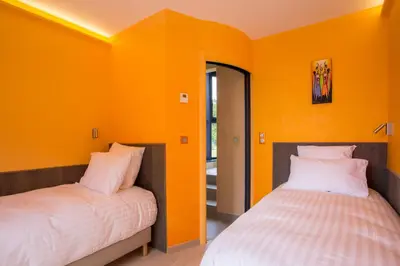 Un ou plusieurs lits dans un hébergement de l'établissement Maison Indigo