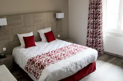 Un ou plusieurs lits dans un hébergement de l'établissement Hotel le Vauxois