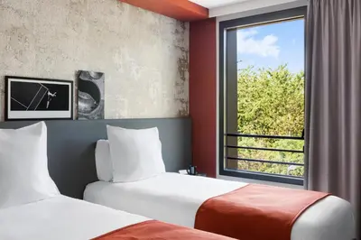 Un ou plusieurs lits dans un hébergement de l'établissement BEST WESTERN HOTEL DIJON QUETIGNY