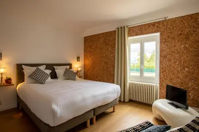 Un ou plusieurs lits dans un hébergement de l'établissement Hôtel Restaurant Gastronomique La Huchette