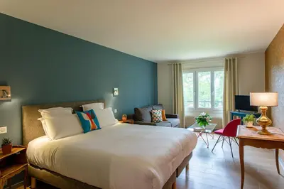 Un ou plusieurs lits dans un hébergement de l'établissement Hôtel Restaurant Gastronomique La Huchette