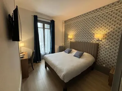 Un ou plusieurs lits dans un hébergement de l'établissement Hotel Le Jacquemart