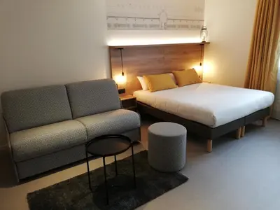 Un ou plusieurs lits dans un hébergement de l'établissement Hôtel des Halles