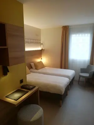 Un ou plusieurs lits dans un hébergement de l'établissement Hôtel des Halles