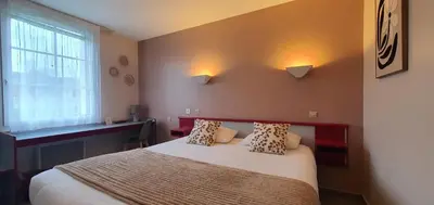 Un ou plusieurs lits dans un hébergement de l'établissement Hotel Saint Odilon