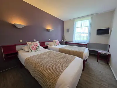 Un ou plusieurs lits dans un hébergement de l'établissement Hotel Saint Odilon