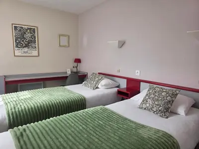 Un ou plusieurs lits dans un hébergement de l'établissement Hotel Saint Odilon