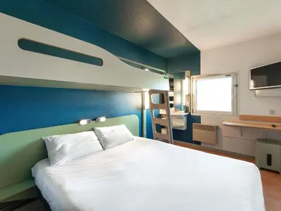 Un ou plusieurs lits dans un hébergement de l'établissement ibis budget Mâcon Nord