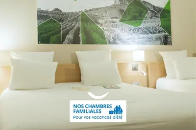 Un ou plusieurs lits dans un hébergement de l'établissement Brit Hotel Mâcon Centre Gare