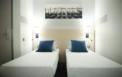 Un ou plusieurs lits dans un hébergement de l'établissement Hôtel Inn Design Dijon Sud