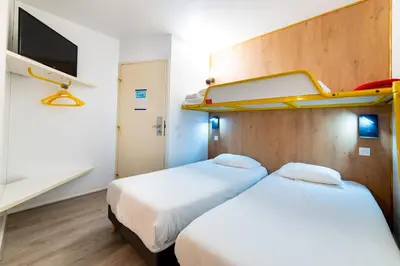 Un ou plusieurs lits dans un hébergement de l'établissement Kyriad Direct Macon Sud