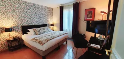 Un ou plusieurs lits dans un hébergement de l'établissement Demeures & Châteaux - Hôtel Greuze & Spa Tournus